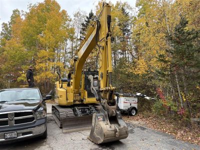  yellow excavator outdoors on a job site