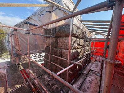 granite bridge pier surrounded by scaffolding